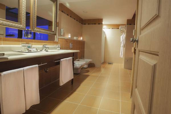 Badezimmer mit zwei Waschtischen, zwei Toiletten und Handtüchern im Fame Residence Lara & Spa Hotel.