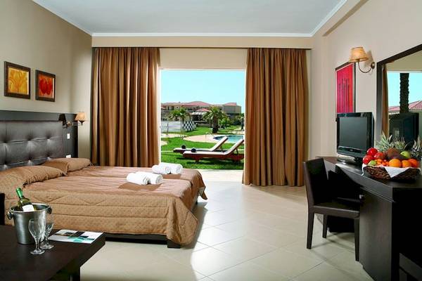 Hotelzimmer im Olympia Golden Beach Resort mit Blick auf den Pool.