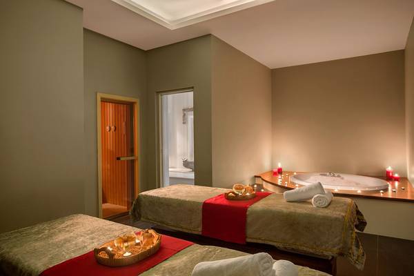 Spa-Behandlungsraum im IC Santai Family Resort mit zwei Massagebetten und einer Badewanne.