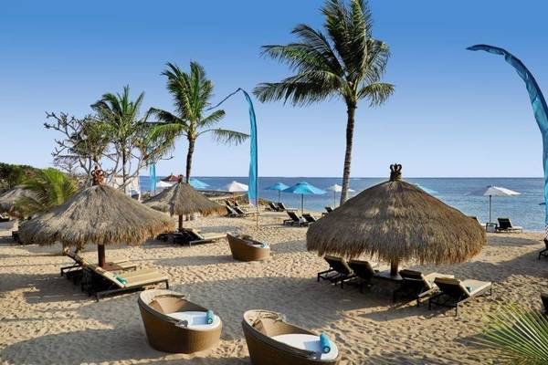 Strand mit Liegestühlen und Sonnenschirmen im Sol Benoa Bali Hotel