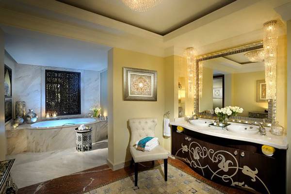 Luxuriöses Badezimmer im Palace At One & Only Royal Mirage mit Badewanne, Spiegel und zwei Waschbecken.