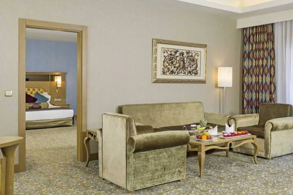 Wohnzimmer des Royal Holiday Palace Hotels mit Sofas, Tisch und Früchten