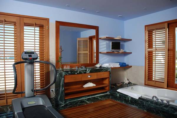 Fitnessbereich im Elounda Bay Palace Hotel mit Tretmühle, Badezimmer und Badewanne