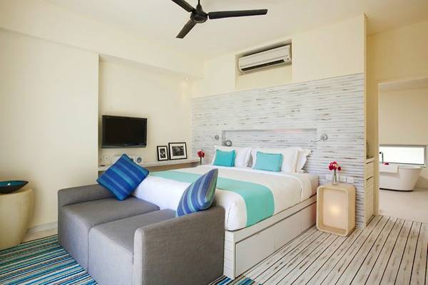 Ferienwohnung im Holiday Inn Resort Kandooma Maldives mit Bett, Fernseher und Klimaanlage.