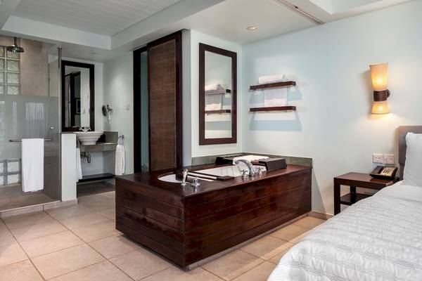 Badezimmer im Fisherman's Cove Resort mit Badewanne, Dusche, Waschbecken und Möbeln.