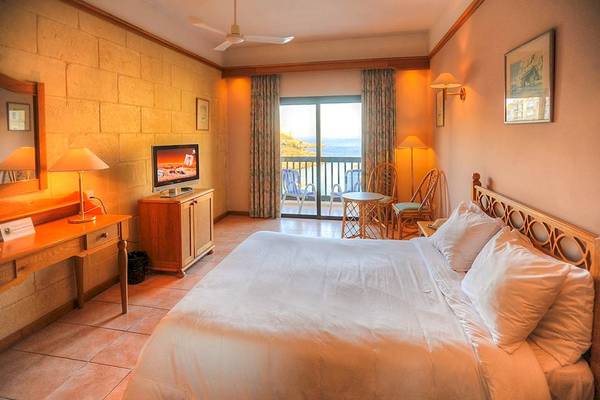 Zimmer im Saint Patrick's Hotel Gozo mit Meerblick, Fernseher und Balkon.