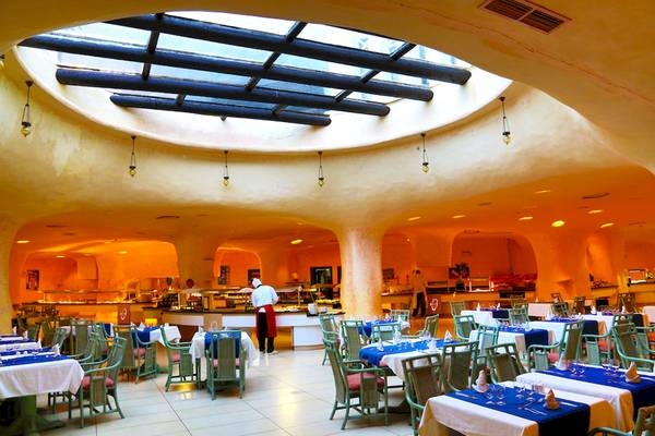 Innenansicht des Restaurants im Odyssee Resort Thalasso & Spa, mit Tischen, Stühlen und serviertem Essen.
