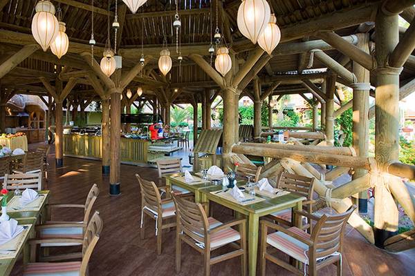 Innenansicht des Restaurants des Kamelya Aishen K Club Hotels mit Holzstrukturen und hängenden Laternen.