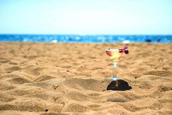 Ein Cocktailglas mit Früchten steht auf dem Strand vor dem Hotel Kamelya Aishen K Club.