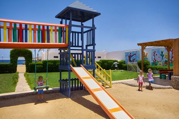 Kinderspielplatz am Arabella Azur Beach Resort mit Rutsche, Schaukel und bunten Wänden.