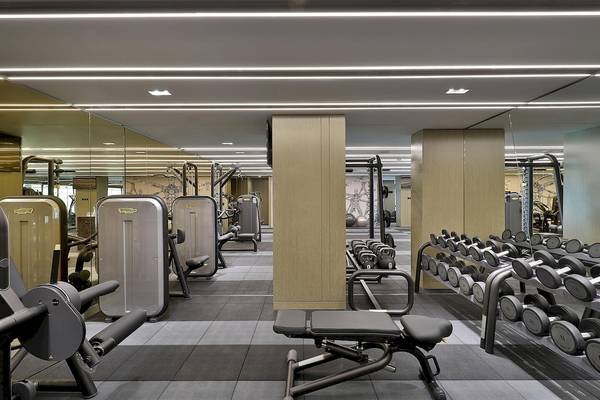 Fitnesscenter im W Muscat Hotel mit verschiedenen Trainingsgeräten und Spiegeln.