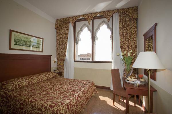 Hotelzimmer im Palazzo Marcello Hotel Al Sole mit einem Bett, Fenstern und Dekor.