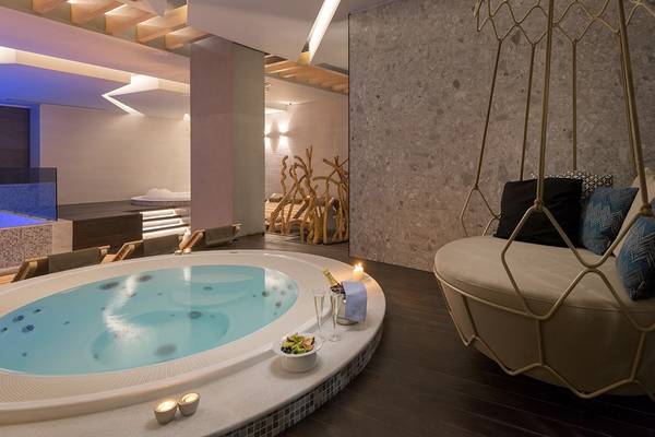 Wellnessbereich im Olympic Palace Resort mit Jacuzzi, Kissen und Champagnerflasche
