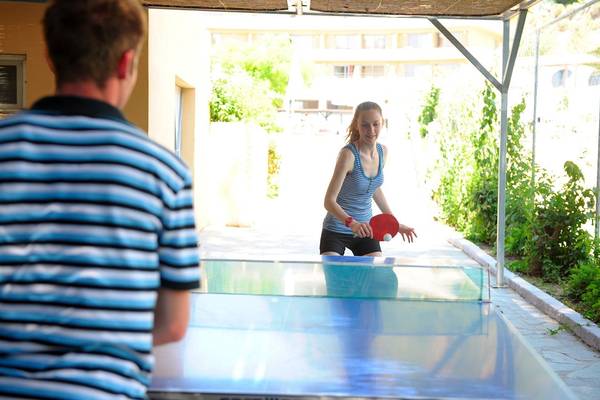 Ein Paar spielt Tischtennis im Freien im Olympic Palace Resort.