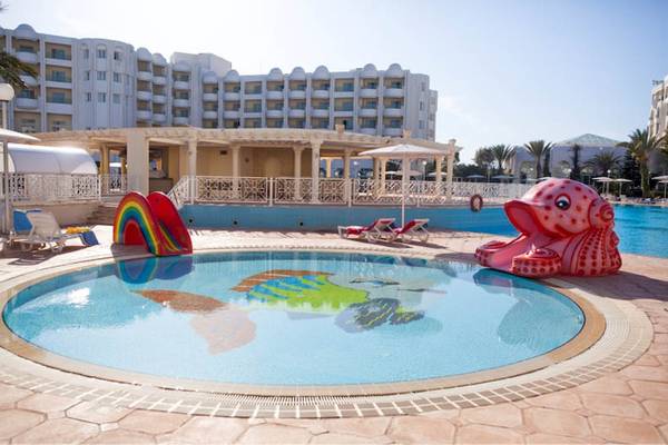 Außenpool des El Mouradi Hammamet Hotels mit buntem Fischbild und Liegestühlen.
