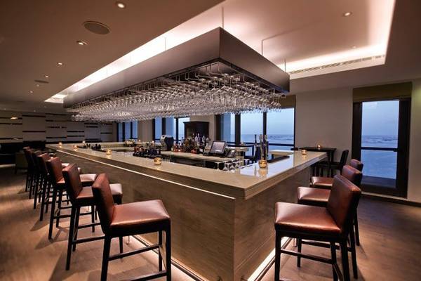 Innenansicht der Bar im JA Ocean View Hotel mit Blick auf das Meer.