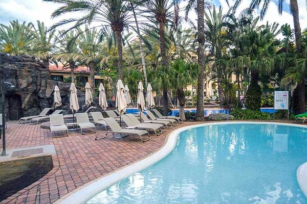Außenpool im Lopesan Costa Meloneras Resort mit Sonnenliegen und Palmen