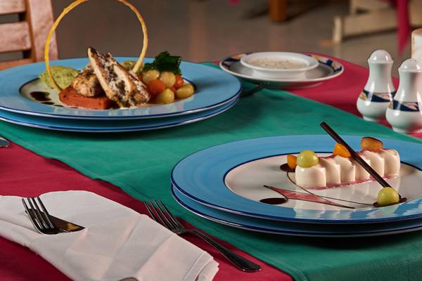 Tisch mit Speisen im Continental Hotel Hurghada, einschließlich Teller mit Dessert und Hauptgericht.