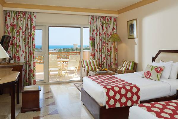 Doppelzimmer mit Balkon im Continental Hotel Hurghada, mit Blick auf das Meer und Möbeln auf dem Balkon.
