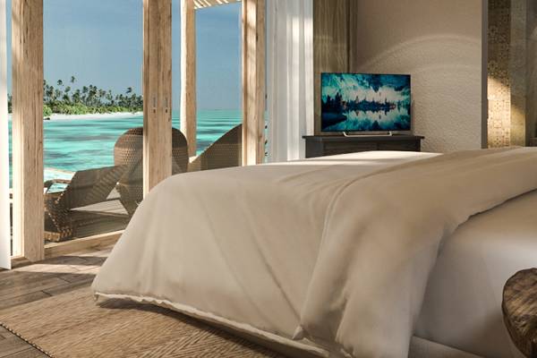 Schlafzimmer mit Meerblick im You & Me Maldives Hotel, mit Fernseher und Balkon.