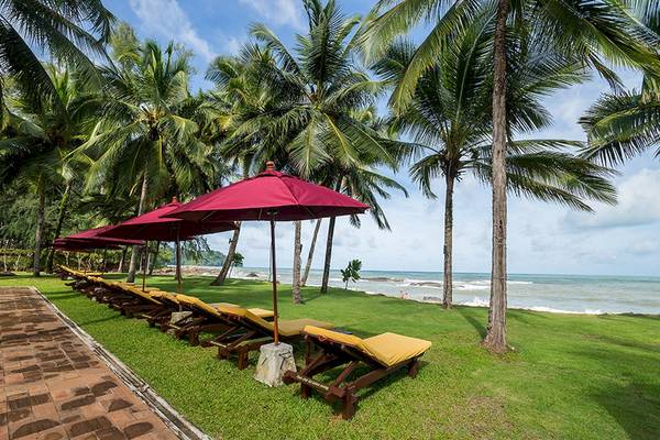 Strandliegen unter roten Sonnenschirmen im Khao Lak Laguna Resort