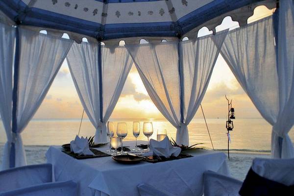 Strandessen im Anantara Dhigu Maldives Resort mit Blick auf den Sonnenuntergang.