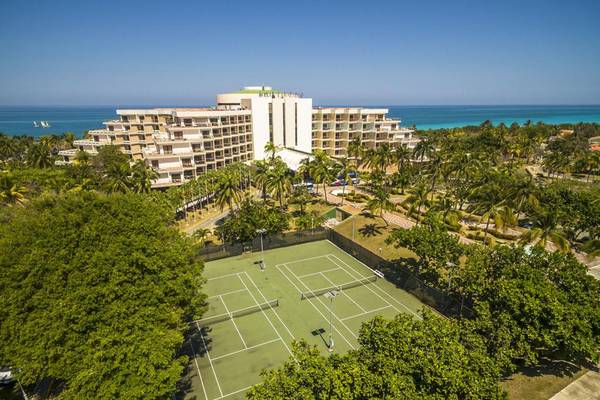 Luftaufnahme des Melia Varadero Hotels mit Tennisplatz und Meer im Hintergrund.