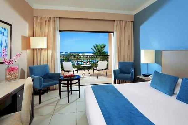 Hotelzimmer im Jaz Aquamarine Resort mit Meerblick und modernen Möbeln.