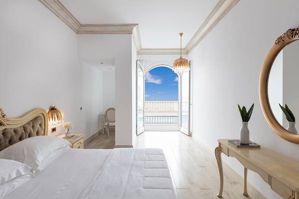 Schlafzimmer im Mitsis Laguna Resort mit Blick auf einen Balkon und Meer