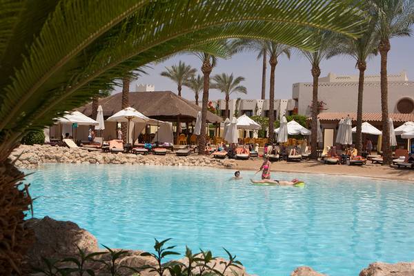 Außenpool im Ghazala Gardens Hotel mit Gästen, Liegestühlen und Palmen