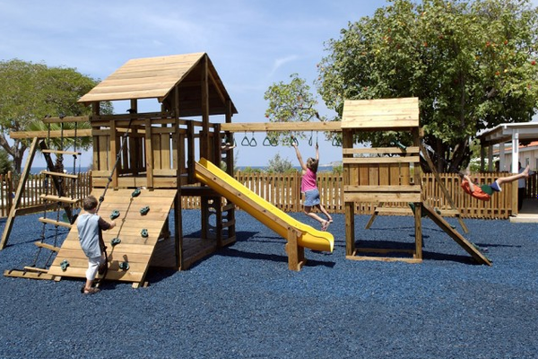 Kinder spielen auf einem Holzspielplatz im Dreams Curacao Resort, Spa & Casino.