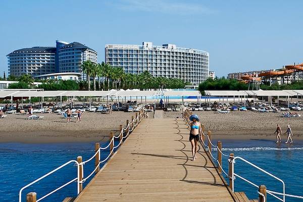 Crystal Centro Resort Strandzugang mit vielen Liegen und Gebäuden im Hintergrund