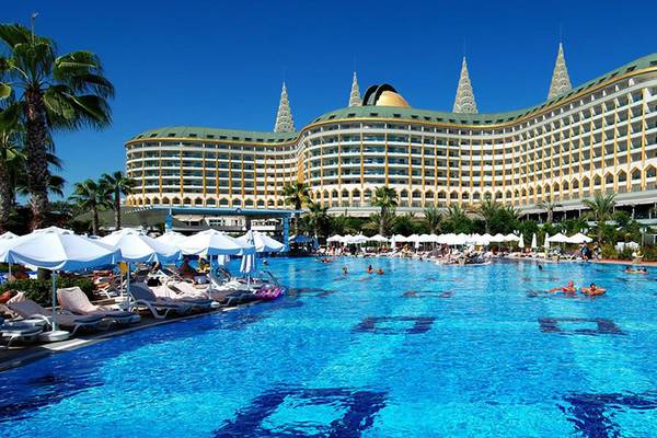 Außenpool des Delphin Imperial Hotels mit vielen Gästen und Liegestühlen.