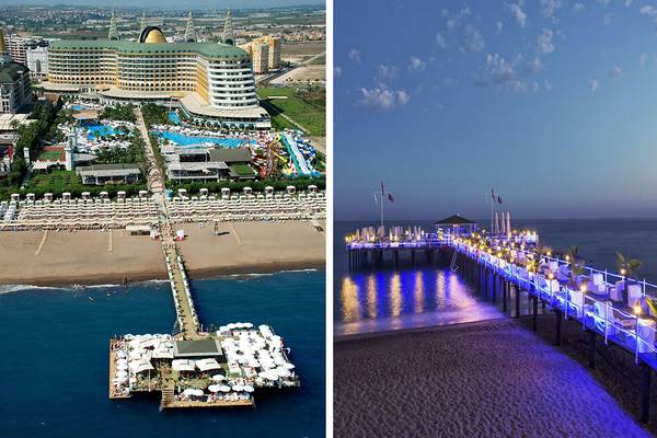 Luftaufnahme des Delphin Imperial Hotels mit Strand und Pier bei Sonnenuntergang
