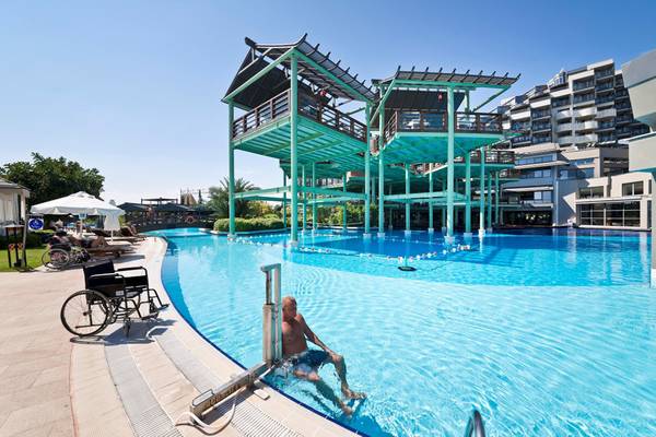 Mann in einem blauen Schwimmbad des Limak Lara De Luxe Hotel & Resort