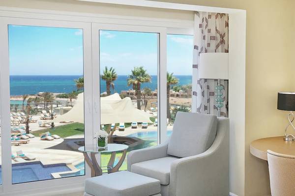 Zimmer im Hilton Hurghada Plaza Hotel mit Aussicht auf den Ozean und eine Terrasse.