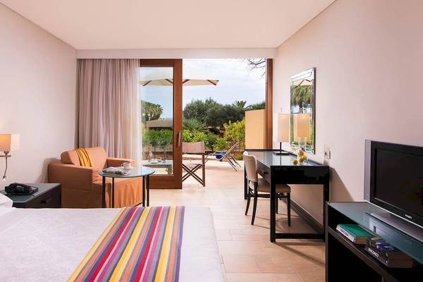 Ein modernes Zimmer im Kernos Beach Hotel & Bungalows mit Blick auf den Garten.