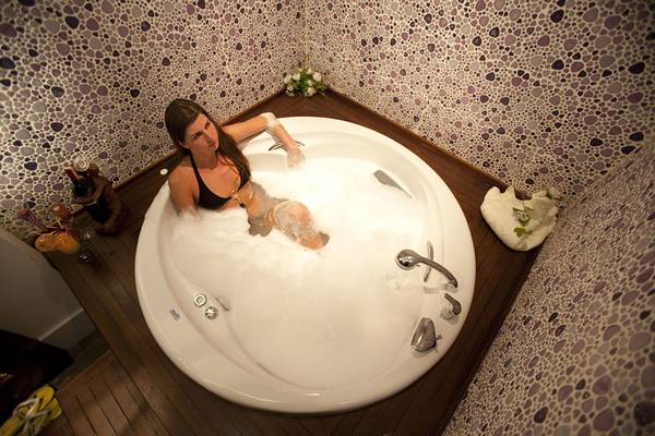 Frau in einer weißen Badewanne voller Schaum im Side Star Resort
