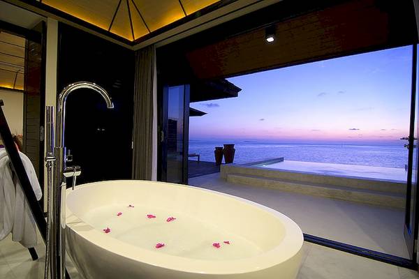 Badezimmer im Lily Beach Resort mit Blick auf das Meer und einem Whirlpool mit Rosenblättern