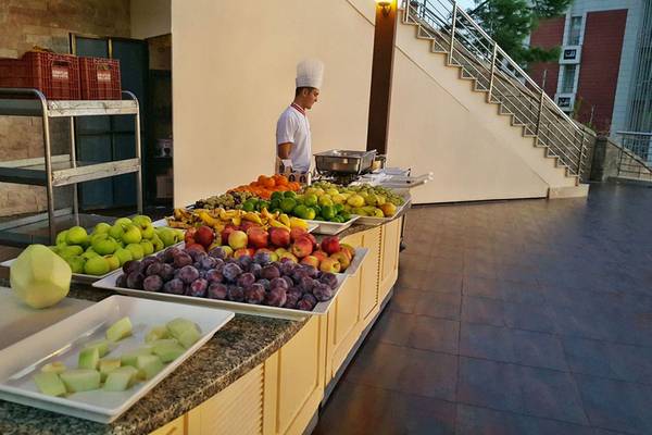 Ein Buffettisch im Horus Paradise Luxury Resort mit verschiedenen Obstsorten, zubereitet von einem Koch.