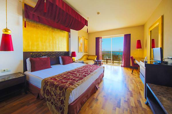 Luxuriöses Hotelzimmer im Horus Paradise Luxury Resort mit Blick auf das Meer.