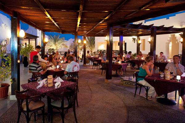 Abendessen im Freien im Sharm Resort Restaurant mit Gästen bei Kerzenlicht.