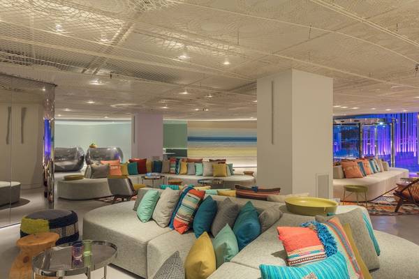 Lobby-Lounge-Bereich des W Ibiza Hotels mit bunten Kissen und modernen Möbeln.