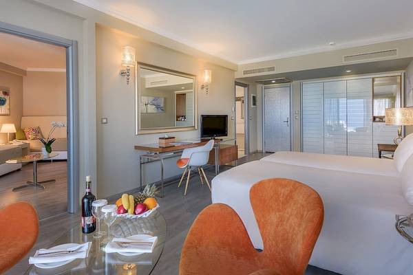 Suite Zimmer im Atrium Platinum Luxury Resort Hotel & Spa mit Schreibtisch, Fernseher und Obstteller.