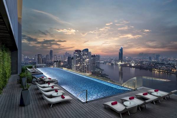 Dachterrasse des AVANI+ Riverside Bangkok mit Infinity-Pool und Blick auf die Stadt