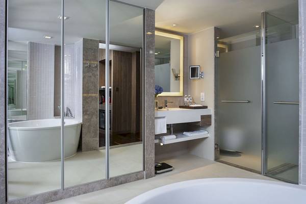 Badezimmer im Novotel Bangkok Sukhumvit 20 Hotel mit Badewanne, Spiegel und Dusche.