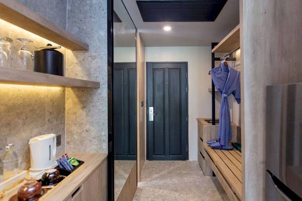 Suite Eingangsbereich im La Flora Khao Lak Hotel mit moderner Einrichtung und blauem Bademantel