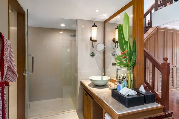 Badezimmer im Santiburi Koh Samui Hotel mit Dusche und Waschbecken.