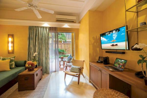 Hotelzimmer im Buri Rasa Village Samui mit Laptop, Fernseher und Balkon.