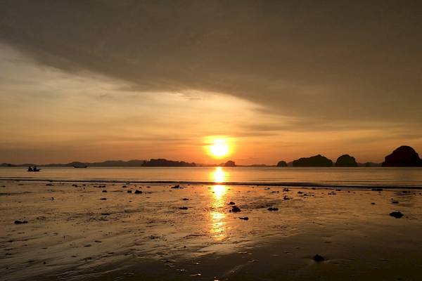 Sonnenuntergang am Tup Kaek Sunset Beach Resort mit kleinen Booten im Wasser und Felsformationen.